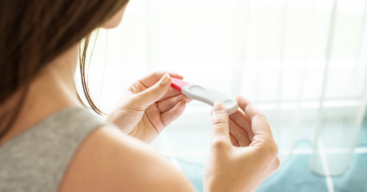 A girl holding a pregnancy test