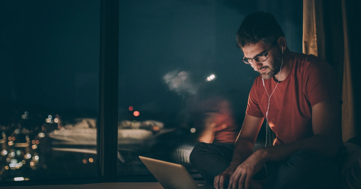 a guy looking on his laptop