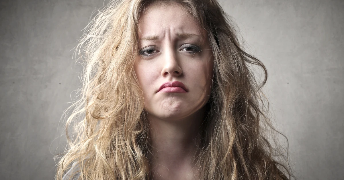 A girl with crazy hair looking sad