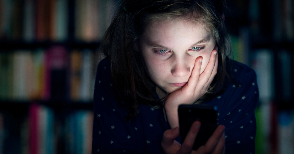 a girl reading words on social media about her