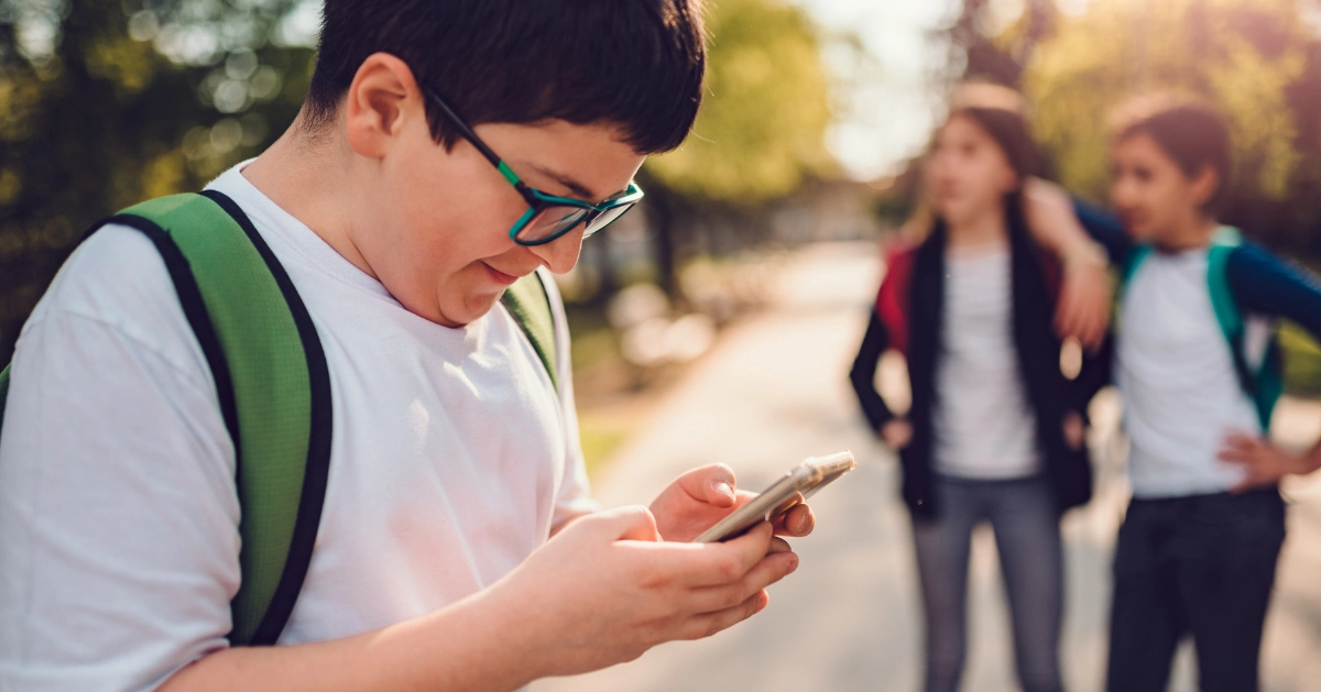 a young boy read his cell phone message