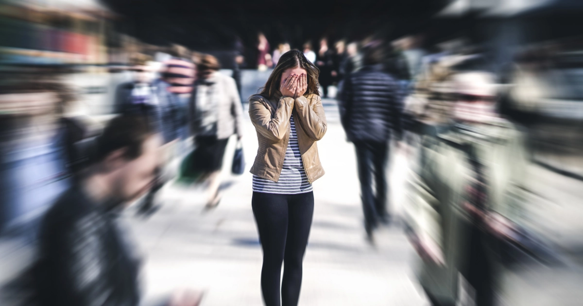 A girl standing in the middle of a crowd
