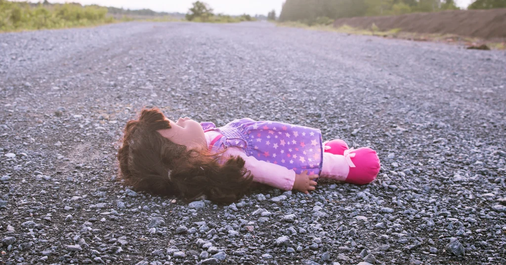 Abandoned doll in the road that signifies emotional abandonment